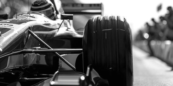 Picture of A black and white photo of a racing car